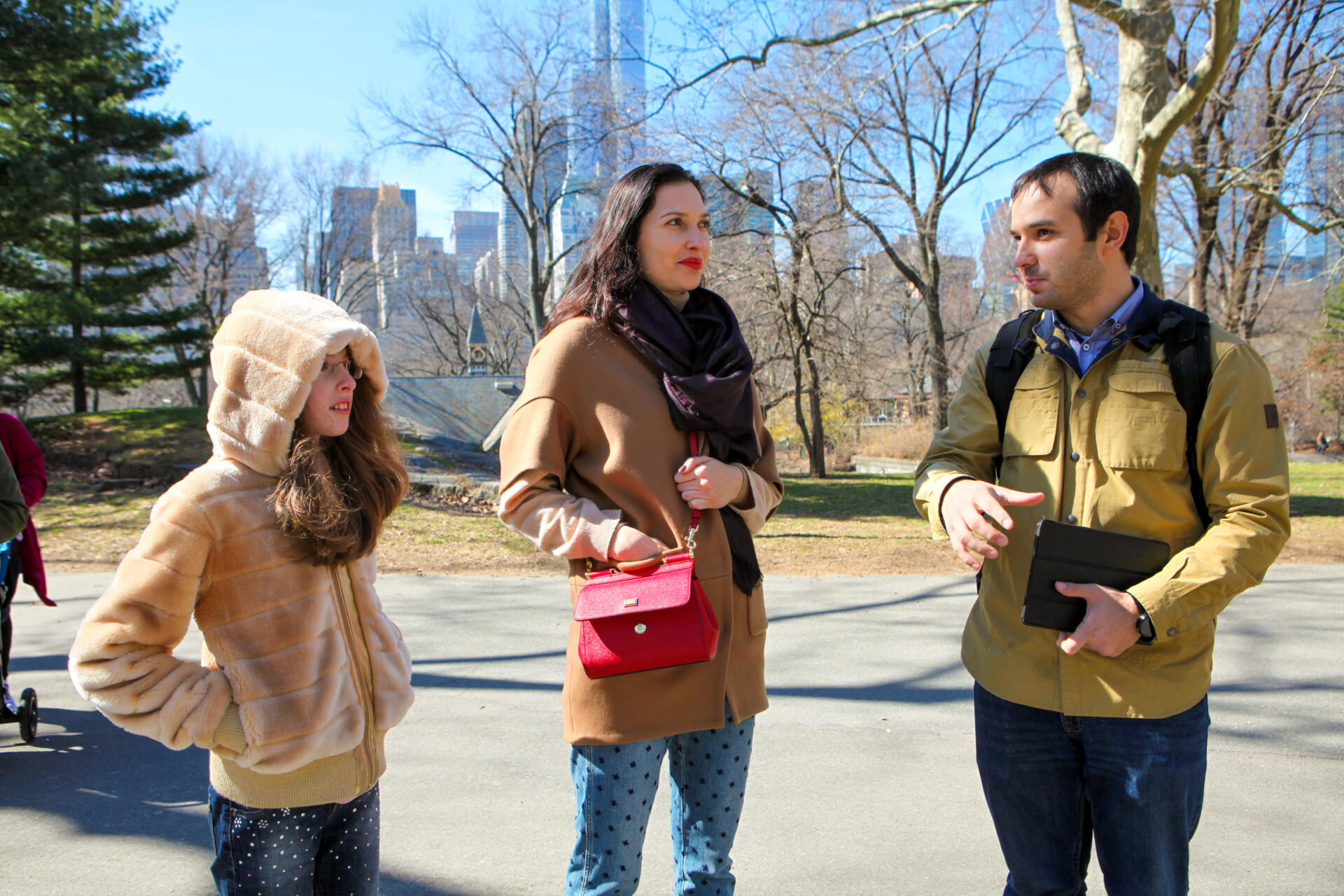 Slava on the right is telling 2 guests, a mom and a daughter, something probably very interesting about central park somewhere near the Dairy