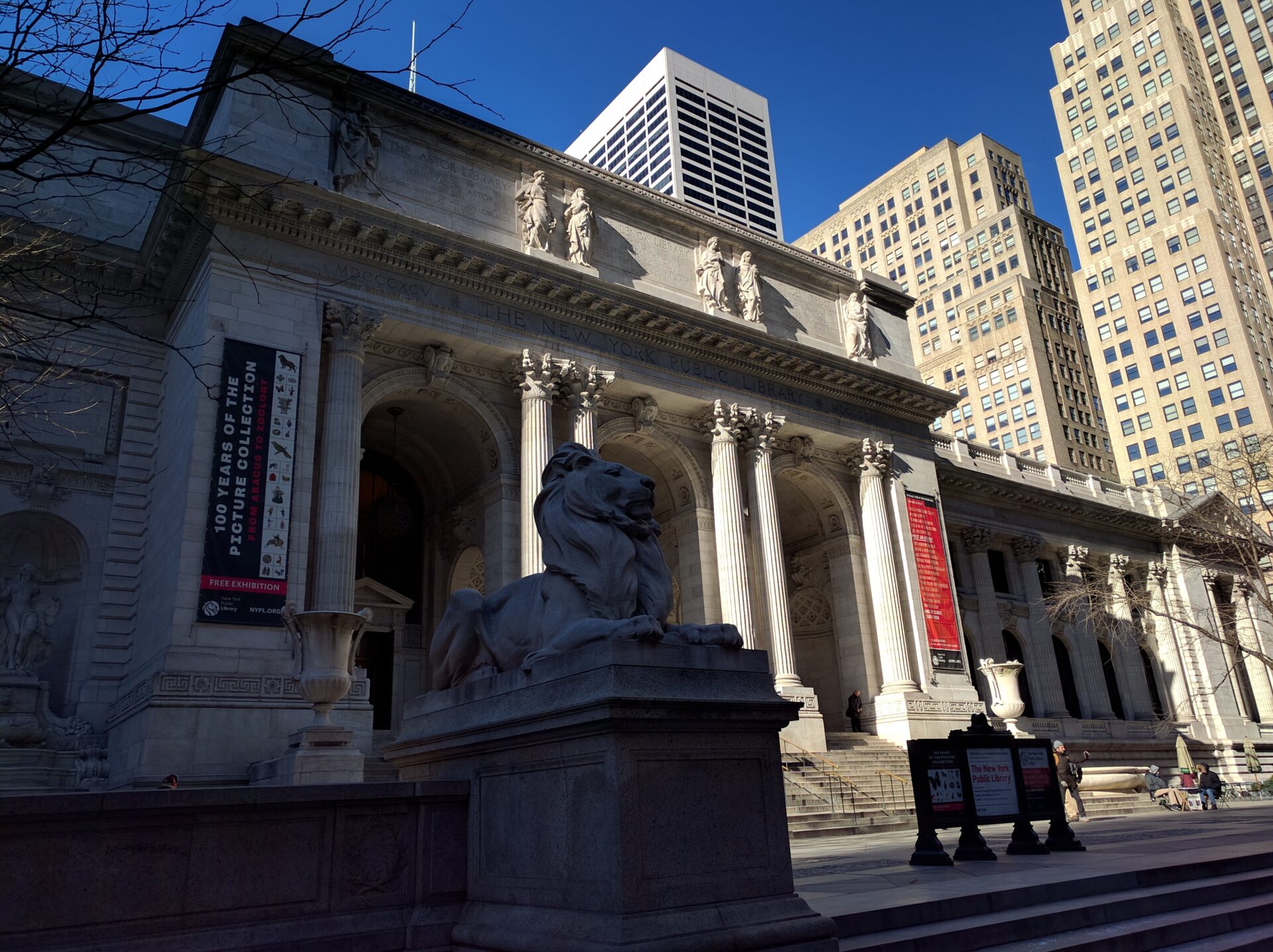 a lion sculpture guards entrance to the New York Public Library's Main Branch on Fifth Avenue