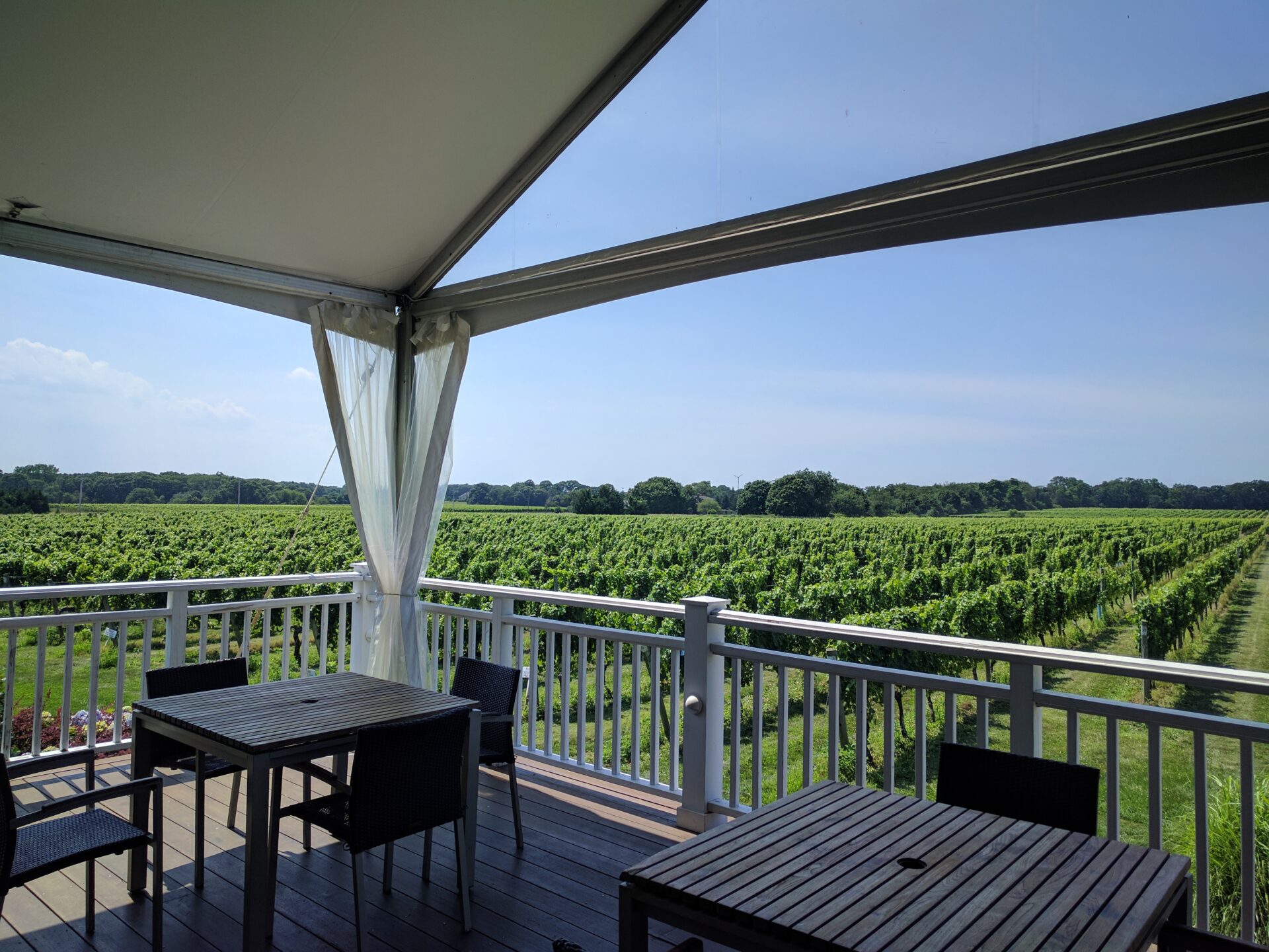 a terrace with a view of a vineyard