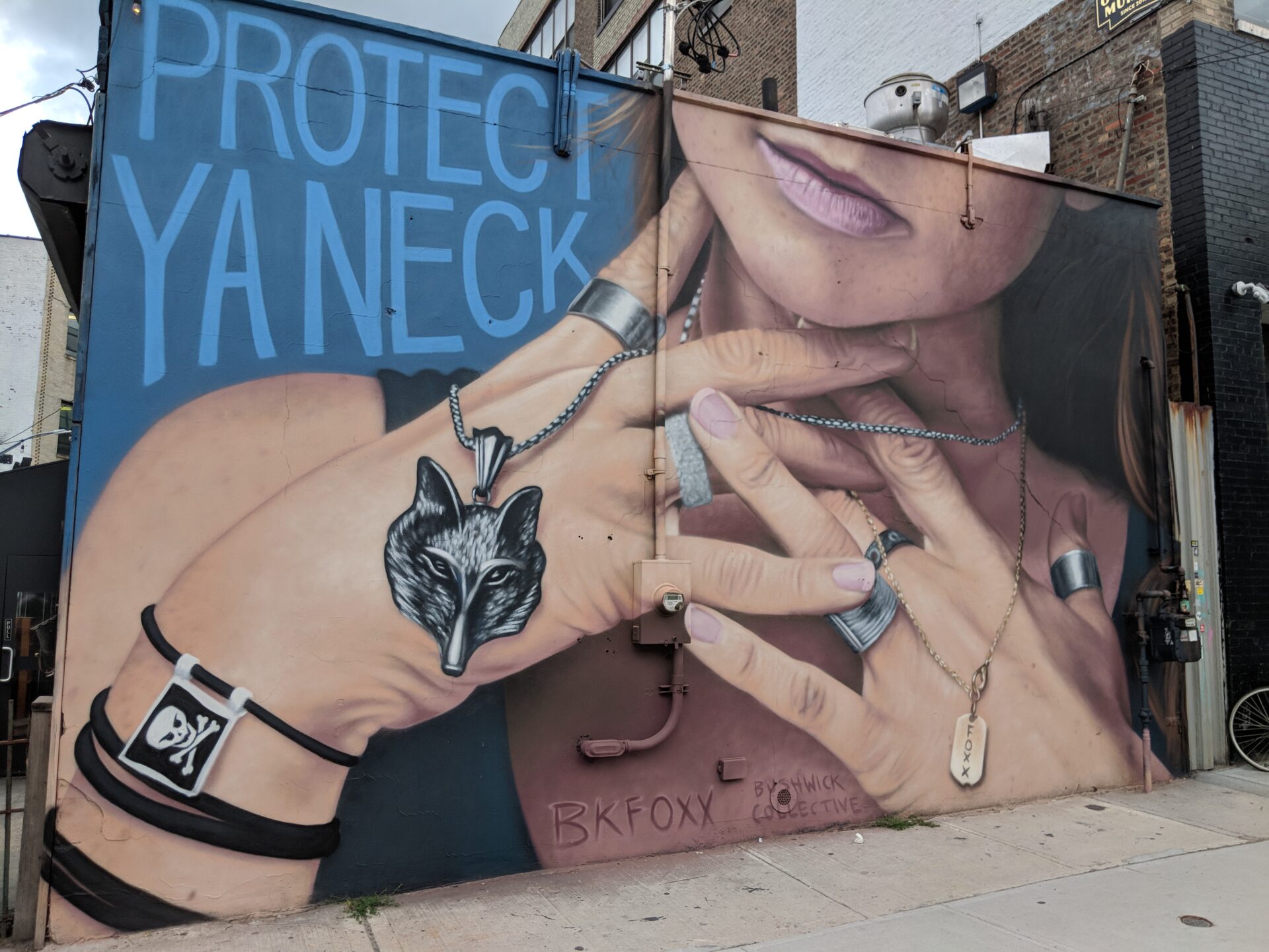 a mural of a girl, grasping her neck; caption: protect ya neck