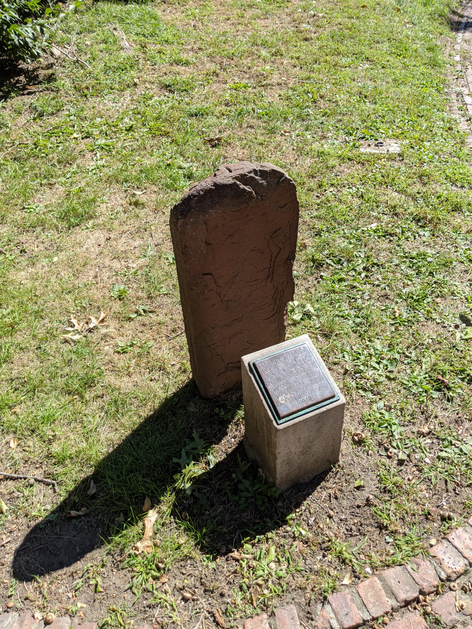 an old milestone and a plaque