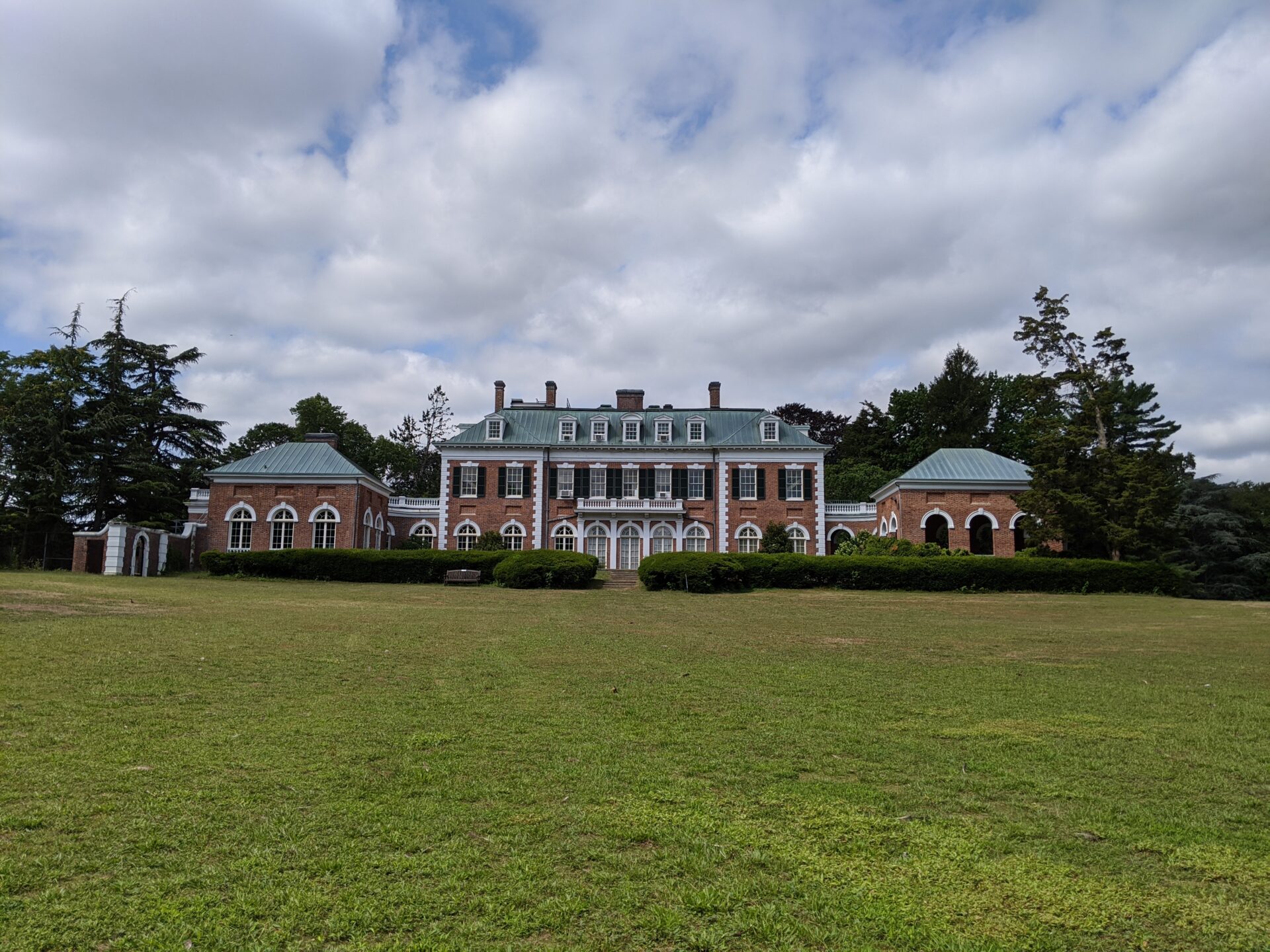 the view of the main building of the nassau county museum of art, lawn in front