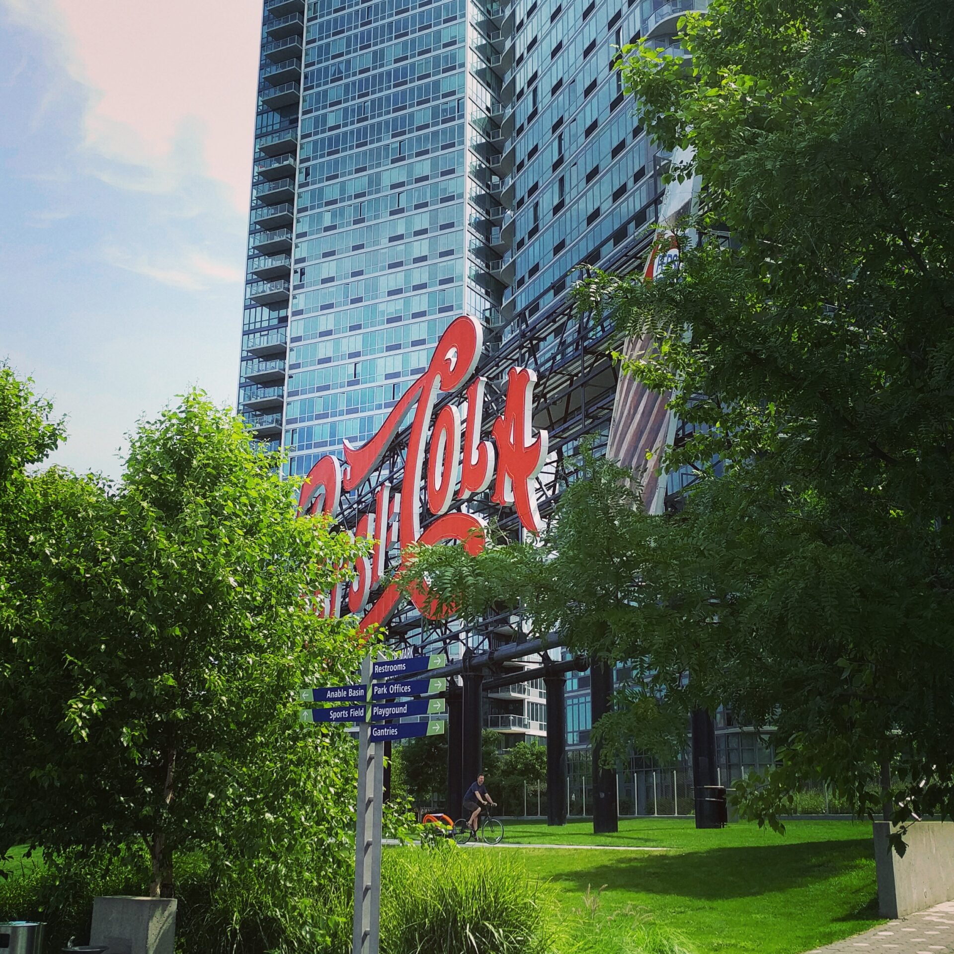 pepsi cola sign behind the trees