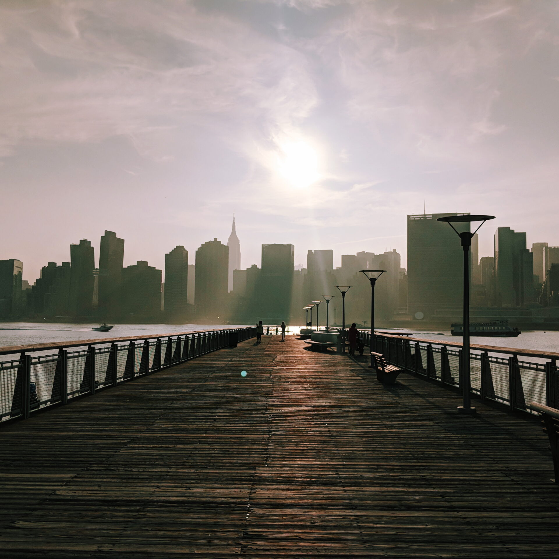 sun shines through the fog on a pier in East River